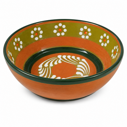 A round ceramic bowl with a terracotta orange exterior, dark green rim, and an olive green interior decorated with white floral patterns and a white central motif.