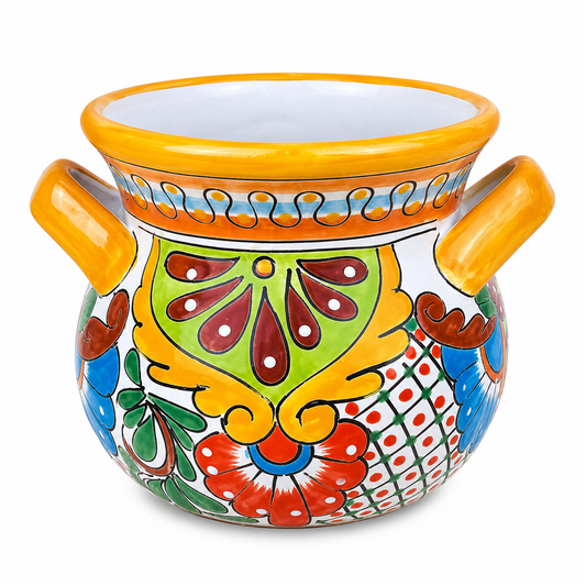 A hand-painted ceramic planter pot with two side handles, featuring a vibrant Mexican Talavera style design with red, green, blue, yellow, and orange patterns on a white background.