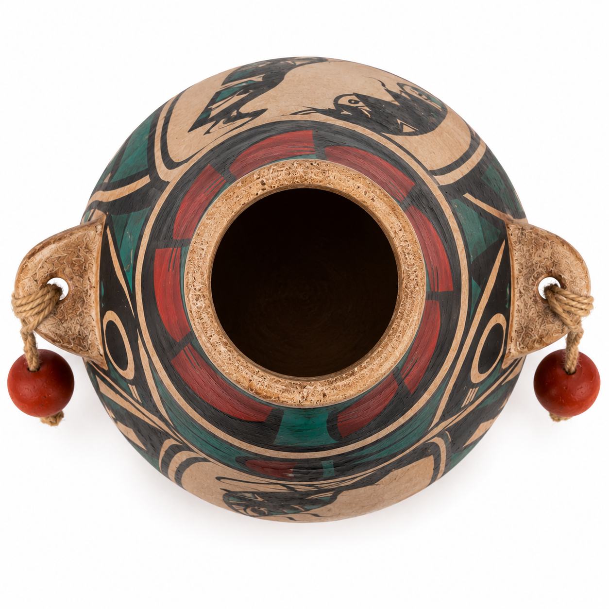 A hand-painted ceramic pot with a circular opening, featuring a tan clay base decorated with red, green, and black geometric and organic patterns. It has two side handles made from natural wood, each attached to a cord loop holding a small red bead.