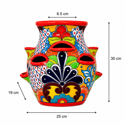 A colorful hand-painted ceramic planter with multiple drainage holes, shown with dimension lines and labels indicating its height of 30 cm, width of 25 cm, and depth of 19 cm.